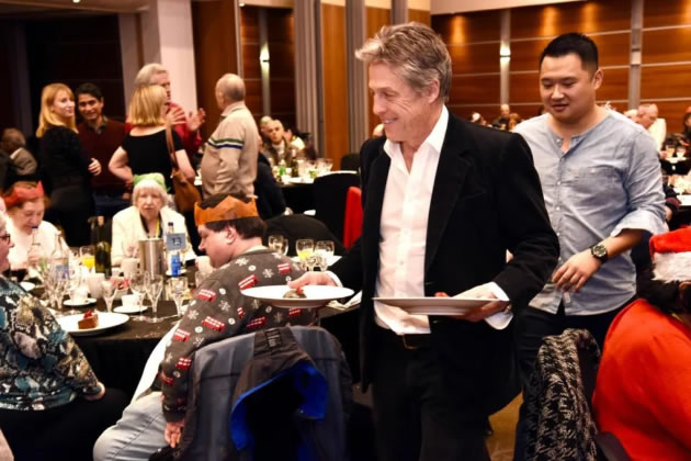 Hugh Grant waits on tables at the charity event