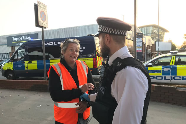 A woman is handcuffed and arrested during the Brentford protest