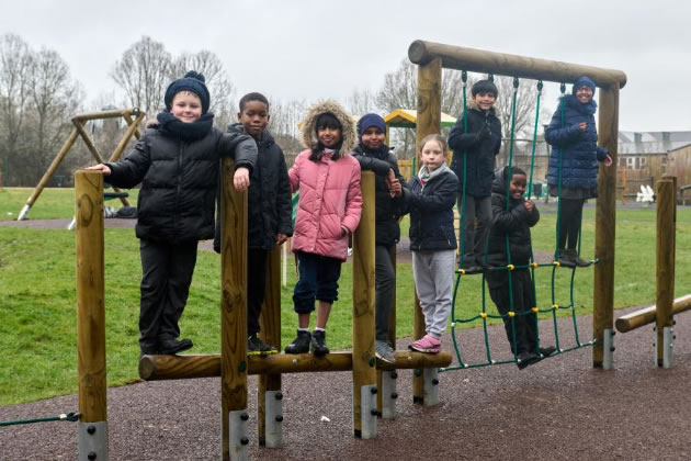 Old Oak Primary School pupils stand on the new climbing frame