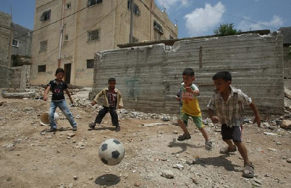 Palestinian boys play football