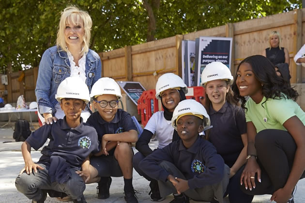 Blue Peter presenters past and present with children from Wormholt School 